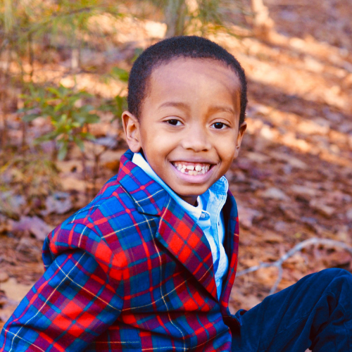 little boy in red and blue plaid suit jacket