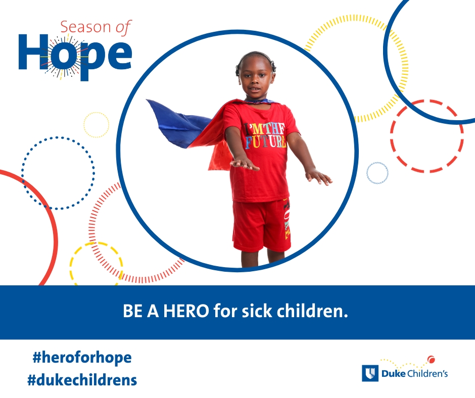 little boy in a super hero costume sitting in a hospital bed - be a hero for sick children