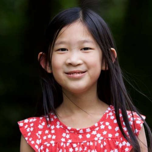 little girl smiling in red and white shirt